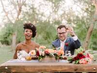 Couple raising toasts after wedding reception speeches.