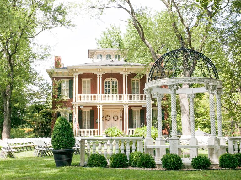 Outside view of The Larimore mansion and white garden pavilion