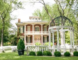 Outside view of The Larimore mansion and white garden pavilion