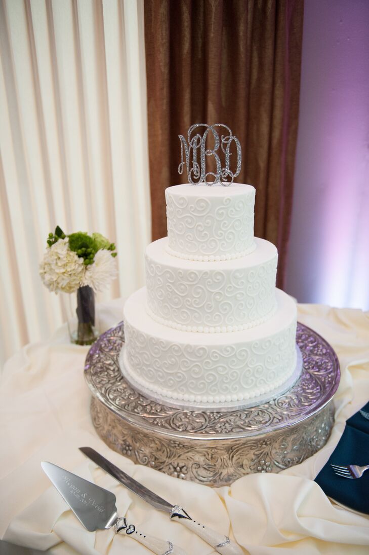 White Swirling Wedding Cake With Monogram Cake Topper