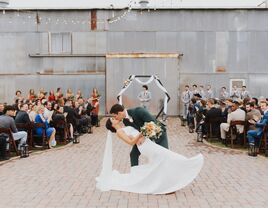 Newlyweds kissing at the aisle during their ceremony