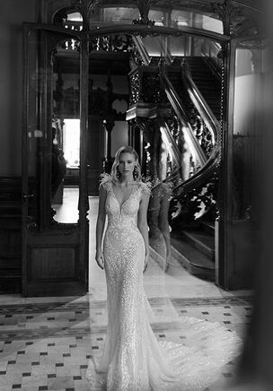 Mermaid silhouette wedding dress with plunging neckline and V-back. Feather straps. Made with beadwork on bodice and skirt.