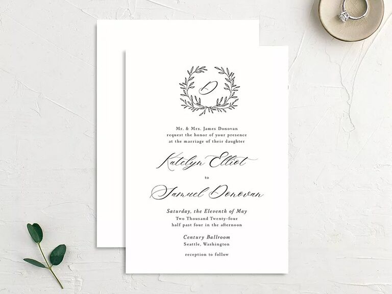 Black wreath with personalized initial above event details and classic script on white background