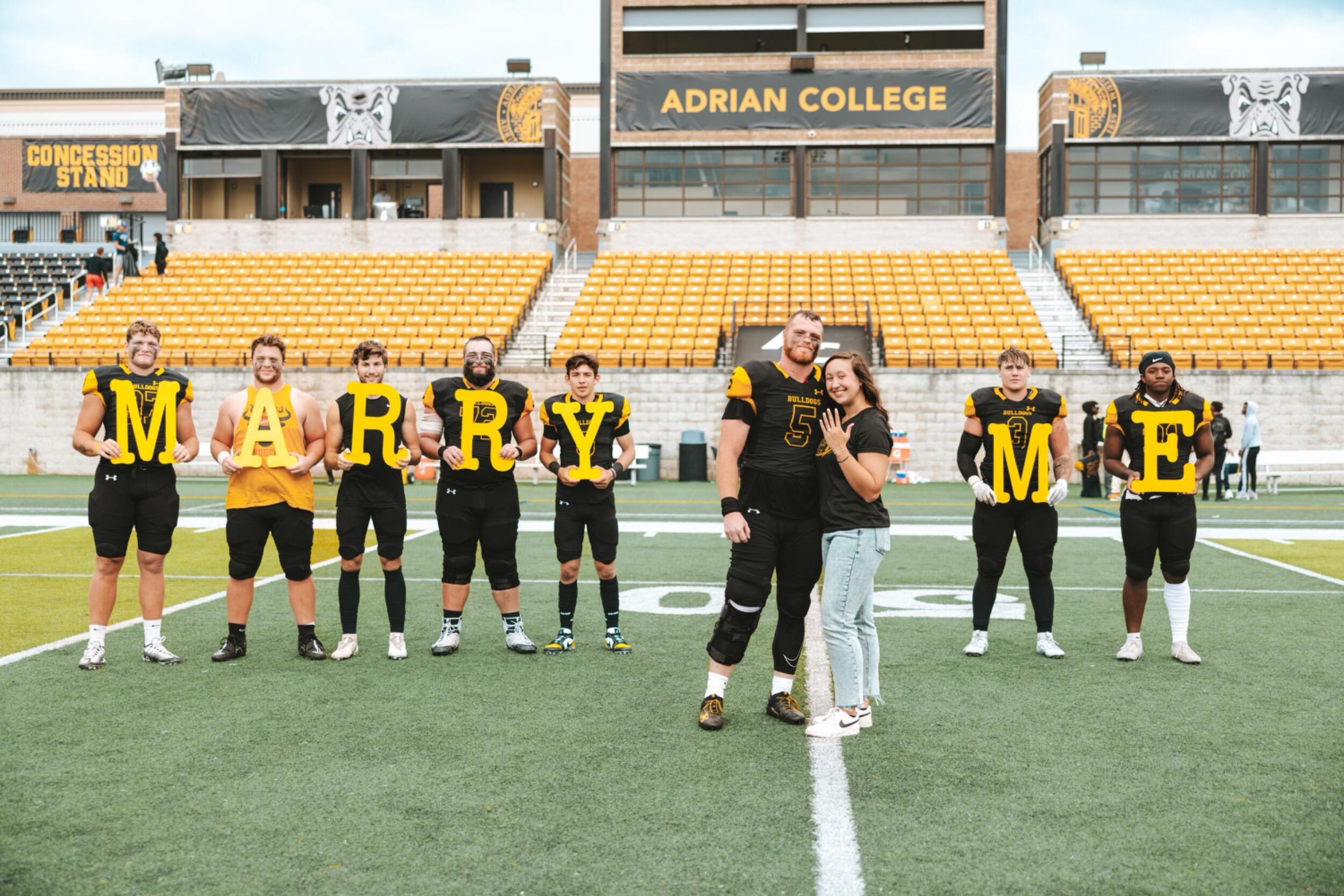 The letters some of Tche’s teammates held during the proposal