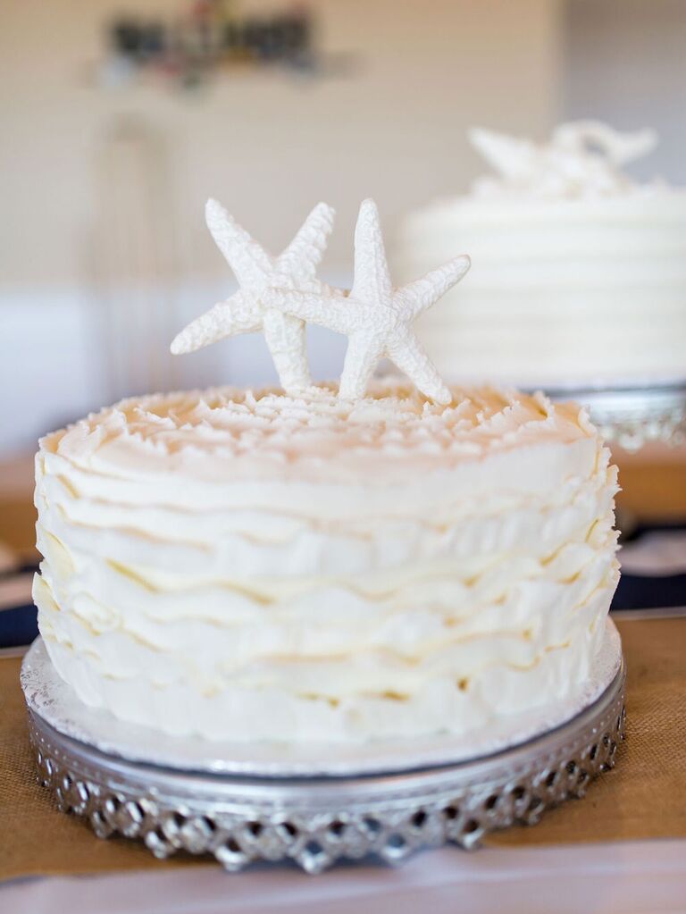 One-tier white beach wedding cake with two starfish as cake topper