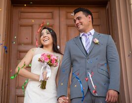 Happy couple coming out of the courthouse after getting married