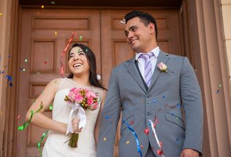 Happy couple coming out of the courthouse after getting married