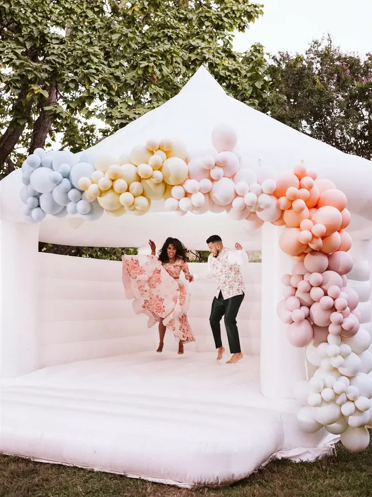 Couple Bouncing in Bouncy Castle at Wedding Welcome Party