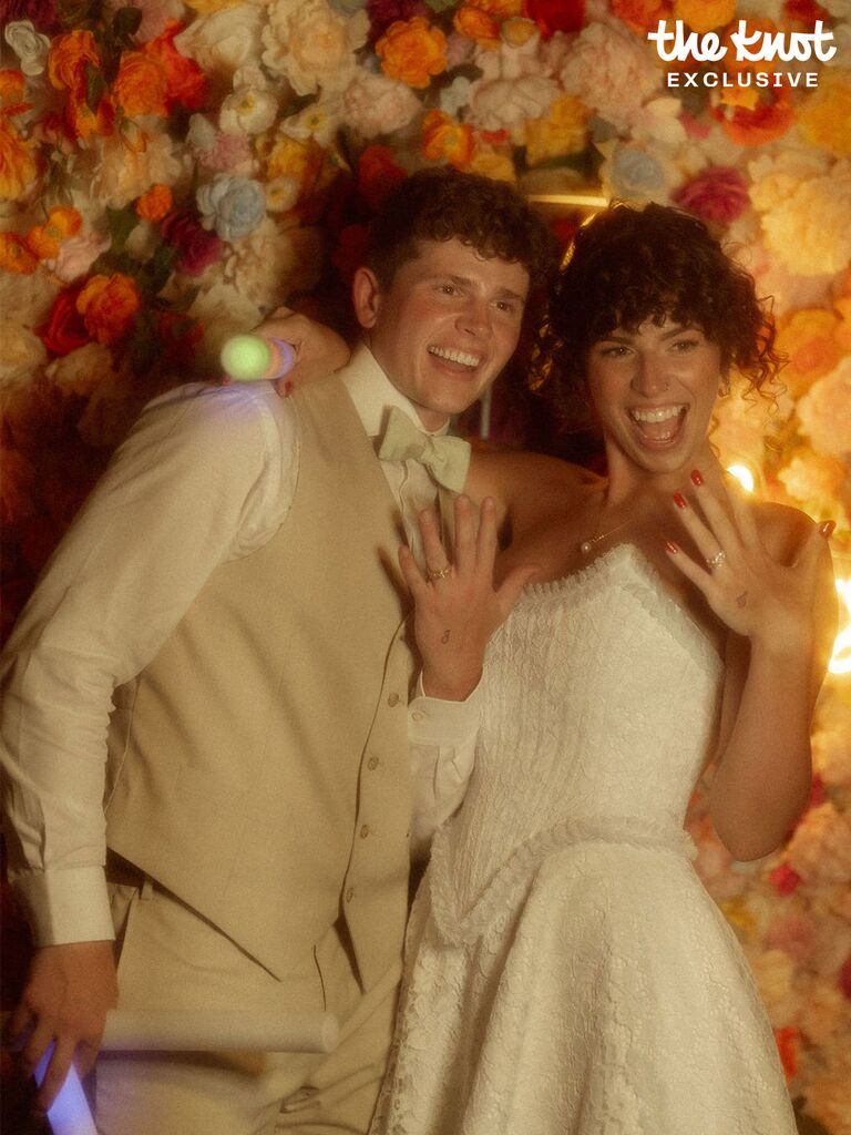 Tommy Winkler and wife Jessica Pappas posing with their wedding rings 