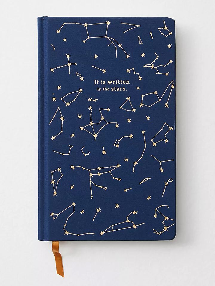 modern wedding vow book with gold constellations against navy blue background