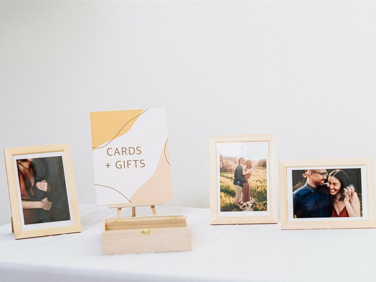 wedding welcome table with framed engagement photos