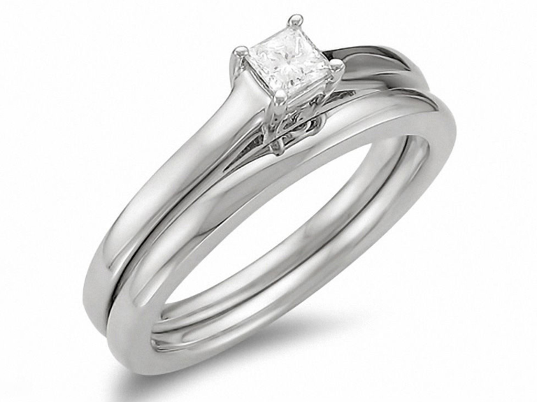 Solitaire princess diamond center stone and matching silver wedding band