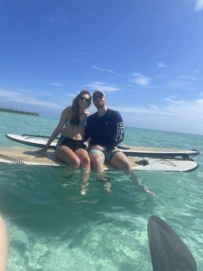 Owen and Allison are paddleboarding on vacation at Cerula Mar