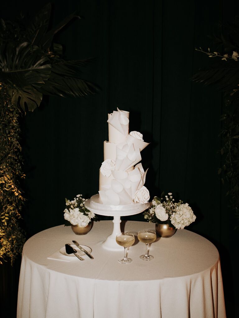 Direct flash wedding photography of cake on cake stand with champagne