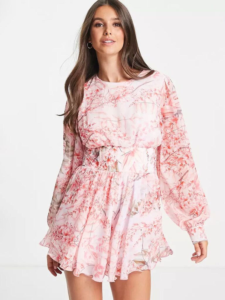 asos light pink bridal romper with pink floral print with high scoop neck loose fitting long sleeves and flowy pleated shorts