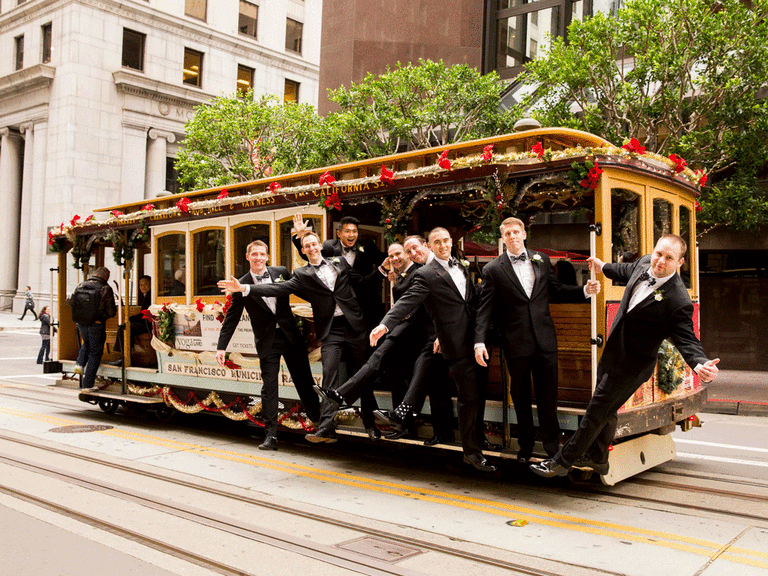 Groom and groomsmen riding a San Franciso trolley. 