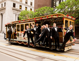 Groom and groomsmen riding a San Franciso trolley. 