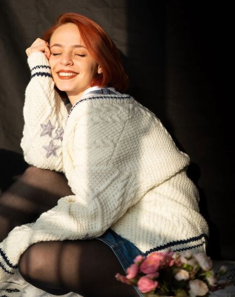 red headed girl in a cardigan