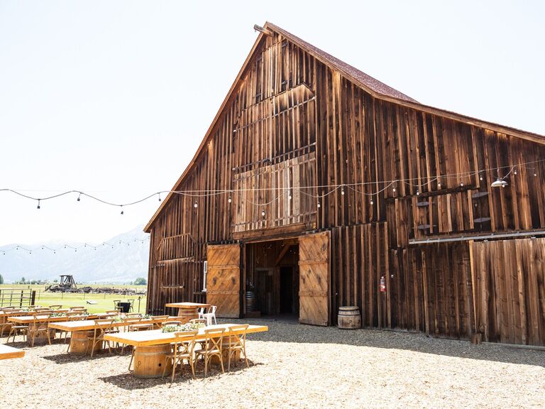 Wedding reception outside wooden barn at Park Home Ranch 