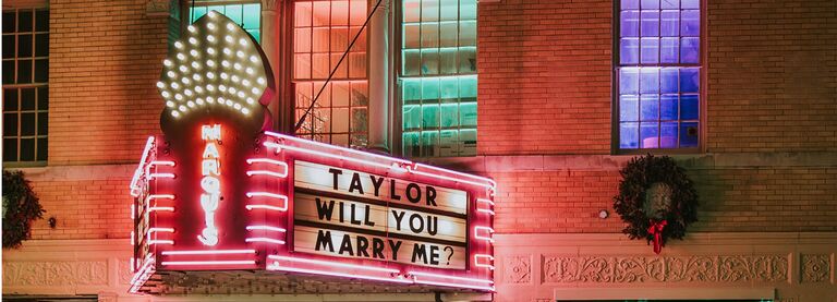 ACT II:
After a few months of dating, we planned our first trip together to Traverse City for a long weekend. It was there that Alan asked Taylor to be his girlfriend while on the swings at a park AND where Alan decided one day he would one day propose at an old theater after an evening show at State Theater.