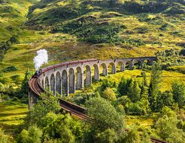 Glenfinnan Railway Viaduct in Scotland with the Jacobite steam train passing over