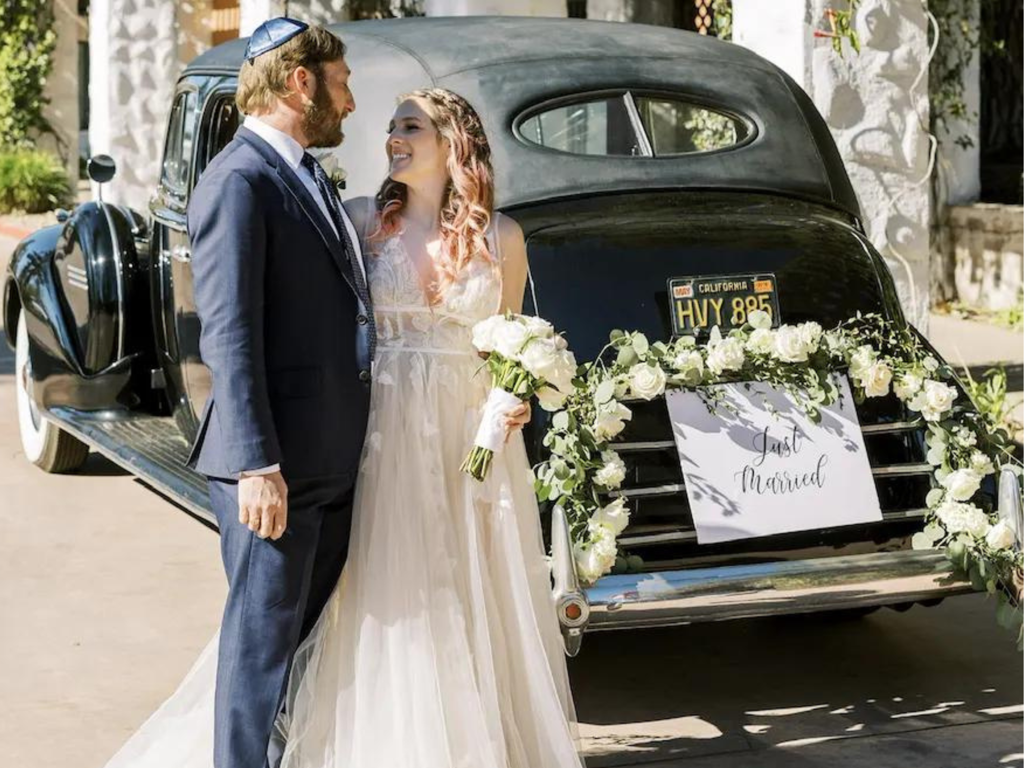 Couple in front of vintage wedding car with just married sign, Los Angeles wedding transportation