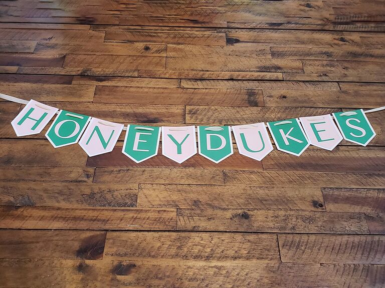 'Honeydukes' banner in alternating mint and white pennant signs