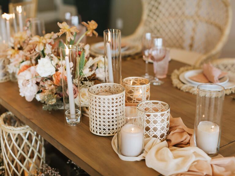 boho wedding centerpiece with rattan vases, white taper candles and neutral wedding flowers