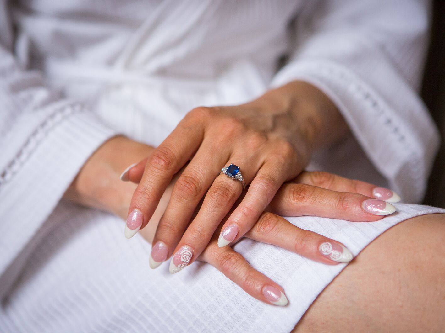 Bride wearing sapphire engagement ring