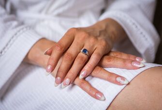 Bride wearing sapphire engagement ring