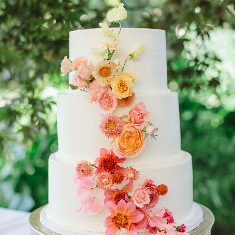 Three-tier cake with ombre cascade of fresh flowers.