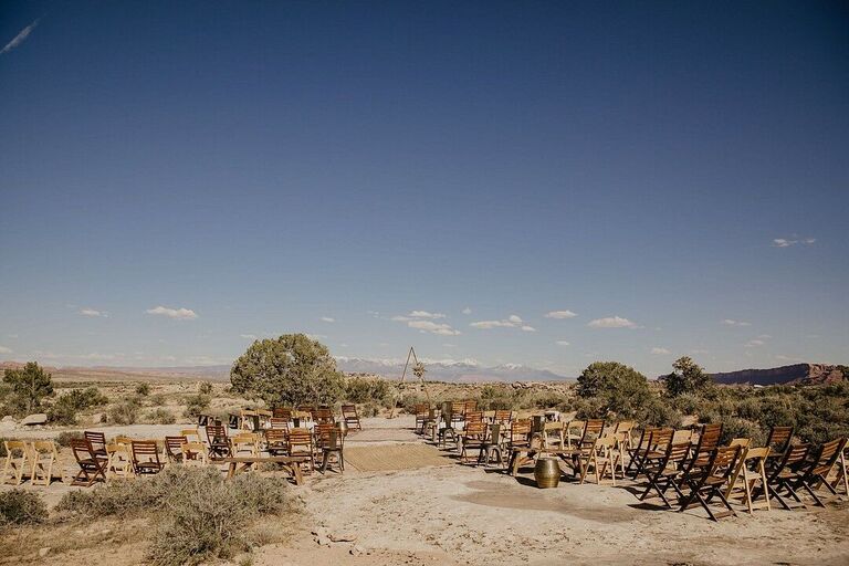 Wedding ceremony in the desert with wood folding chairs