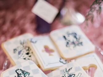 Decorated Alice In Wonderland–themed cookies for a whimsical wedding