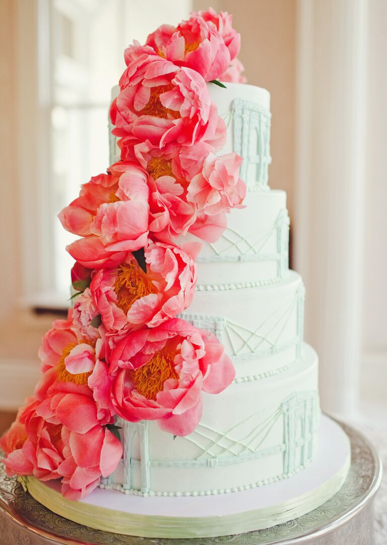 Classic white wedding cake with bright pink peonies