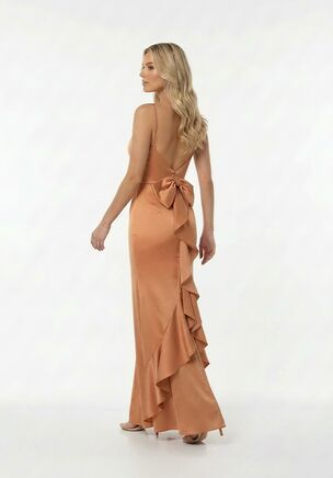 This fitted A-line bridesmaid dress in Lux Charmeuse is playful, romantic, and effortlessly chic. Delicate spaghetti straps and a natural waist create a flattering silhouette, while the back of the skirt steals the show with a romantic bow and cascading ruffles. Flirty, elegant, and full of movement, it’s perfect for bridesmaids who want to feel stylish and unforgettable.