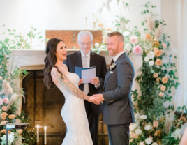 Bride and groom holding hands at the altar