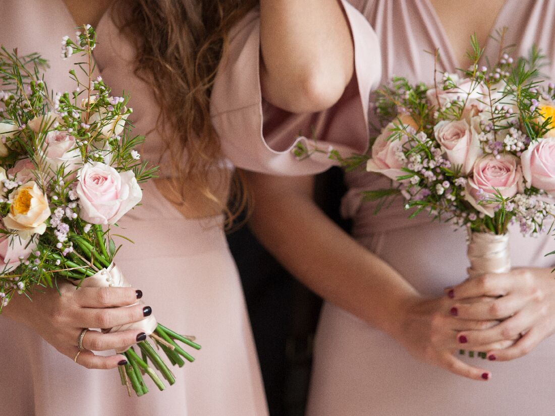 Closeup of two bridesmaids holding wedding flowers