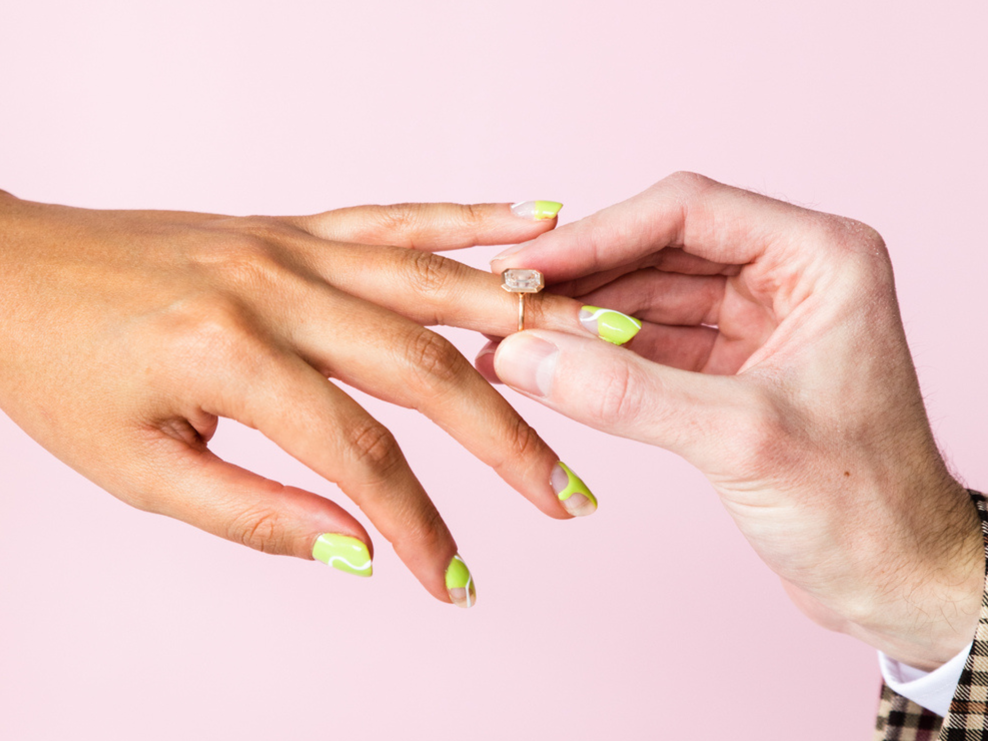 Person putting engagement ring on woman's hand