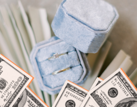 Diamond engagement ring sitting atop a silver wedding band.