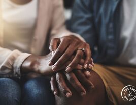 Close-up of couple interlocking hands 