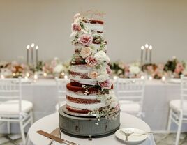 four tier semi naked wedding cake with chocolate sponge, pink and ivory roses and queen anne's lace