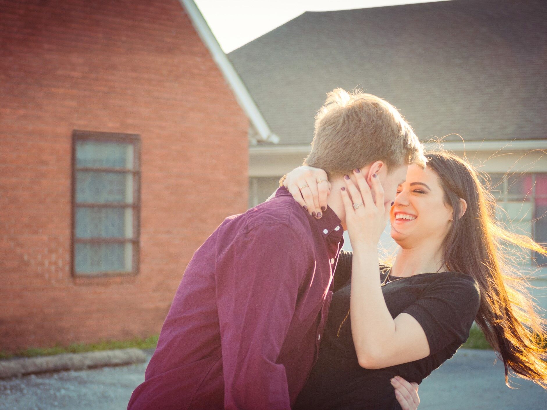 Happy couple laughing while holding onto each other