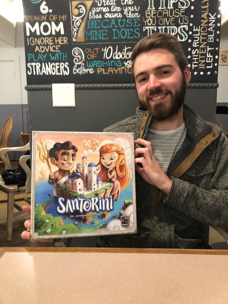We first met online and had our first date at Kingmakers Board Game Parlor, bonding over shared tastes in board games, video games, and music. Santorini became a calling card for us and is the inspiration for our home Wifi name. 😝