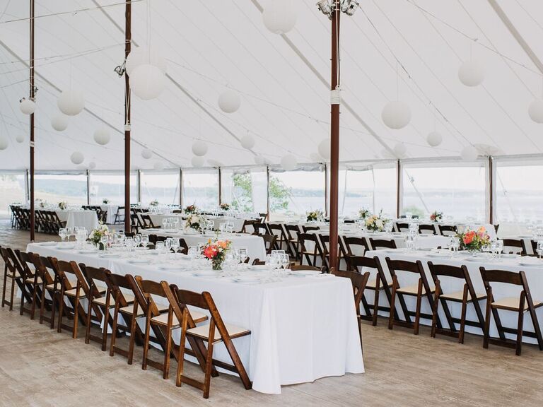 Inside white tent with foldable wooden chairs and hanging white balls