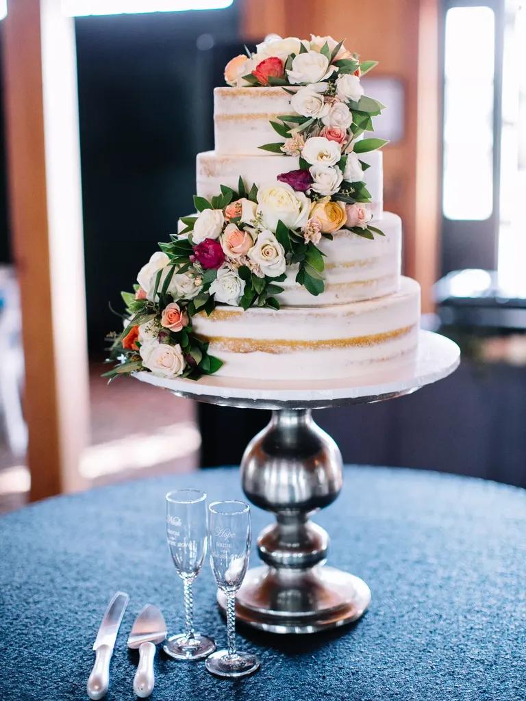 Naked four tier wedding Cake With Rose Garland