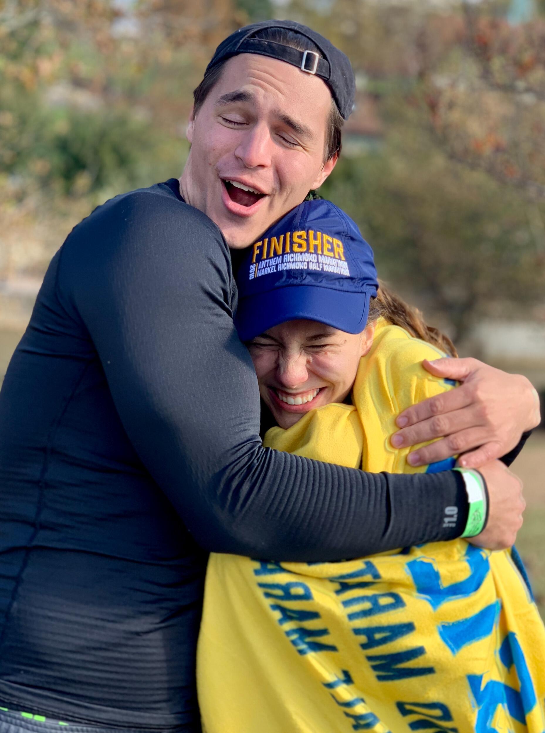 Noah celebrates Emily as she finishes the Richmond Half Marathon!