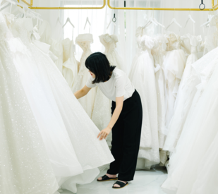 Woman looking at wedding dresses, buy and sell used wedding dresses