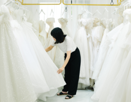 Woman looking at wedding dresses, buy and sell used wedding dresses