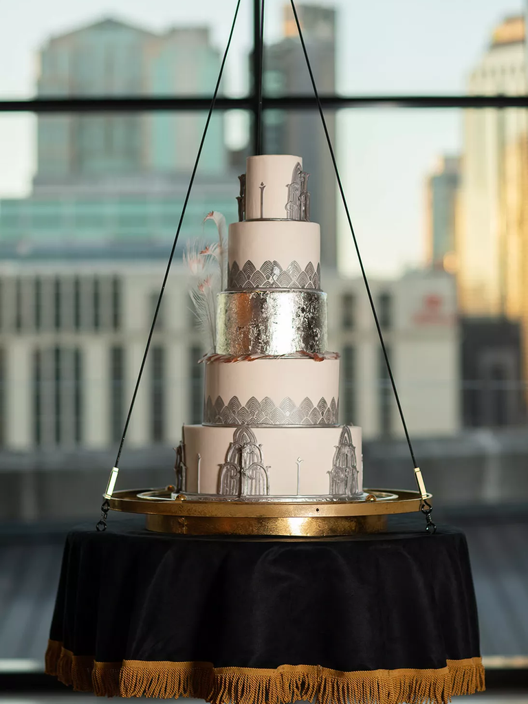 Art Deco Wedding Cake with silver accents on a gilded swing