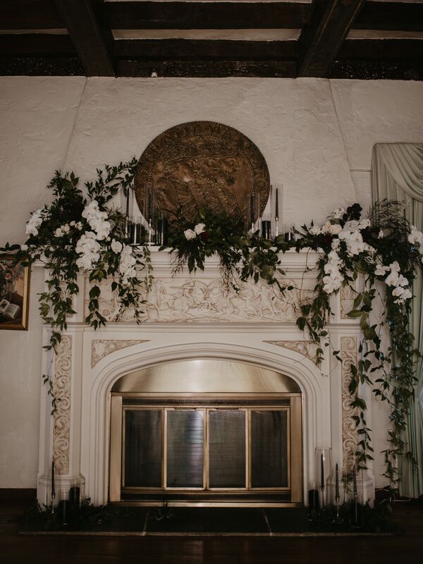 Dark academia fireplace wedding decor